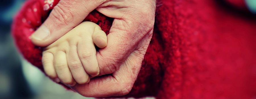 Person holding a babies hand