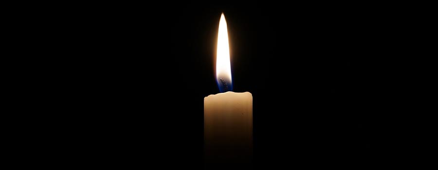 A single candle lit in a dark room