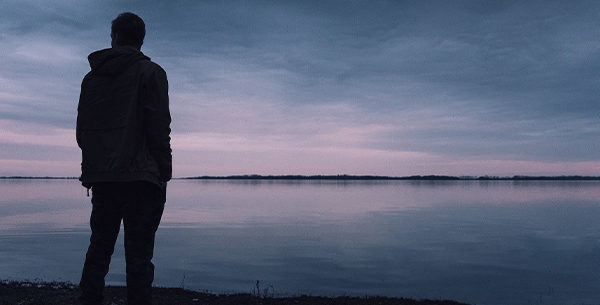 Man staring out into the sea in the evening