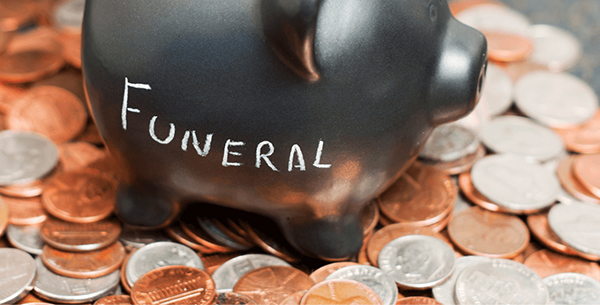 Piggy bank with funeral written on the side in chalk