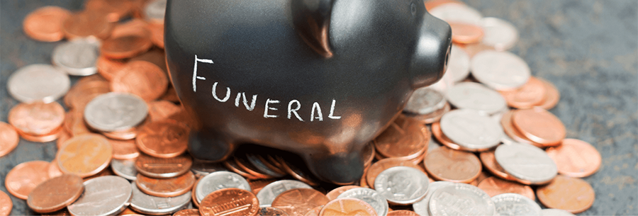 Piggy bank with funeral written on the side in chalk