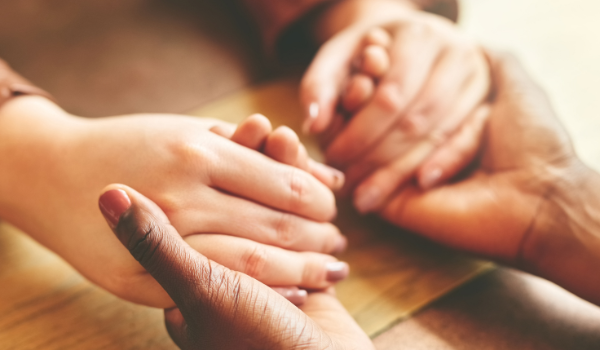 two sets of hands holding each other