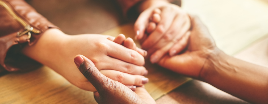 two sets of hands holding each other