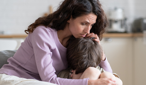 adult comforting a grieving child